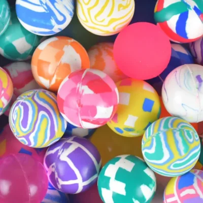 Colorful assorted 27mm bouncy balls in a vibrant mix, perfect for vending machines, party favors, and arcade prize bins.