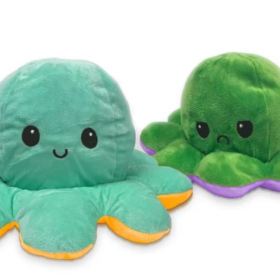 Reversible octopus mood plush toy featuring a happy teal octopus and a sad green octopus with contrasting orange and purple accents on a white background.