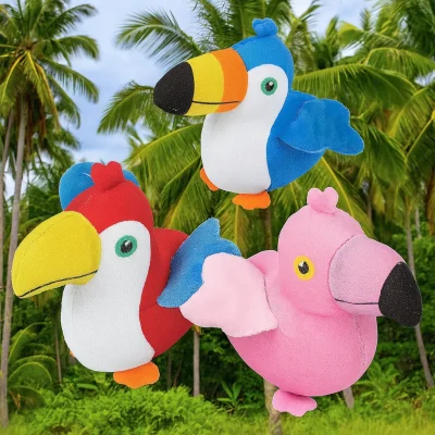 "Three plush tropical bird toys—a red and yellow toucan, a blue toucan, and a pink flamingo—set against a lush tropical backdrop with palm trees."