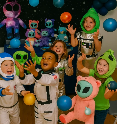 Children dressed as aliens and astronauts at a space-themed party with galaxy decor and prizes