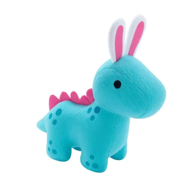 “Plush blue dinosaur toy with pink bunny ears, pink back spikes, and blue spot details, displayed against a clean white background.”
