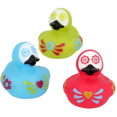 Group Image: "Set of three Day of the Dead themed rubber ducks in blue, red, and green with decorative floral and heart patterns, displayed on a white background."