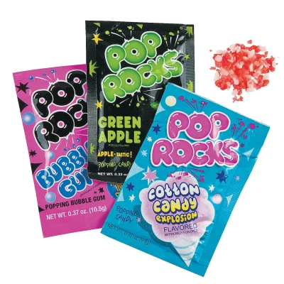 Pop Rocks assorted popping candy packets—Cotton Candy, Green Apple, and Bubble Gum—plus candy crystals on a white background.