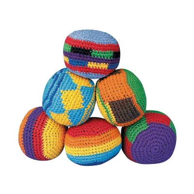 Mini knitted hacky sack balls stacked on white background in assorted multicolor patterns