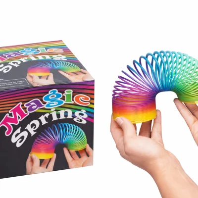 Rainbow Magic Spring toy displayed next to retail box packaging on white background showing product scale and bulk presentation