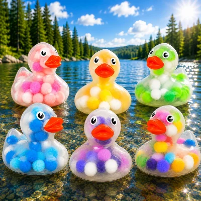 Colorful pom-pom rubber ducks displayed in a sunny mountain lake with pine trees.