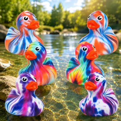 Colorful tie-dye rubber ducks in assorted swirl patterns displayed on a sunny pond.